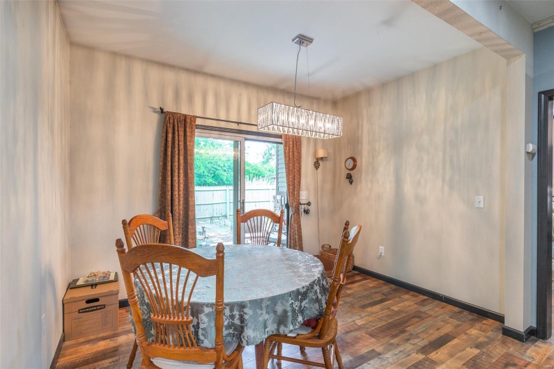Dining area with dark wood finished floors, a chandelier, and baseboards