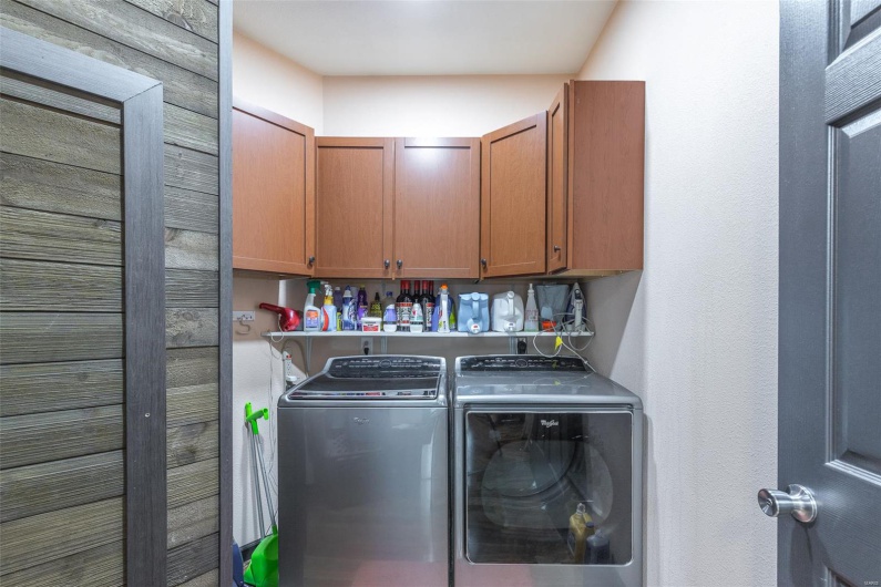 Laundry area featuring washer and clothes dryer and cabinet space