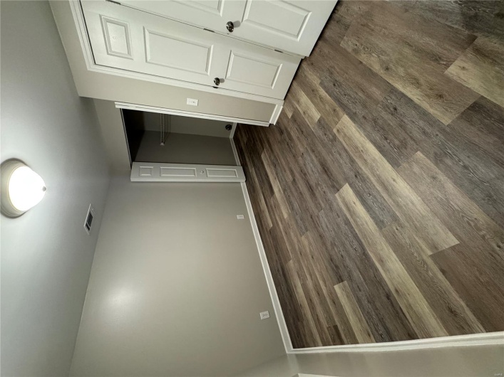 Unfurnished bedroom with dark wood finished floors, a closet, and baseboards