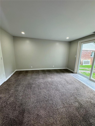 Carpeted spare room with baseboards and recessed lighting