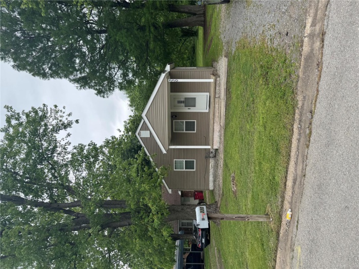 Bungalow-style house with a front yard and covered porch