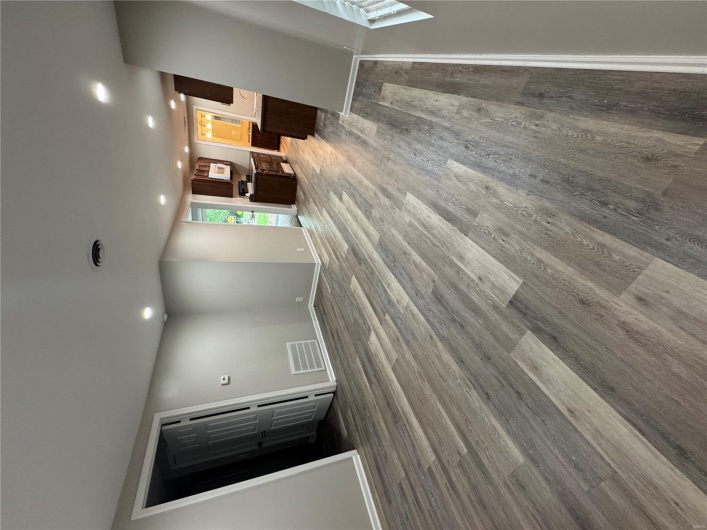 Unfurnished living room with recessed lighting, dark wood finished floors, and baseboards
