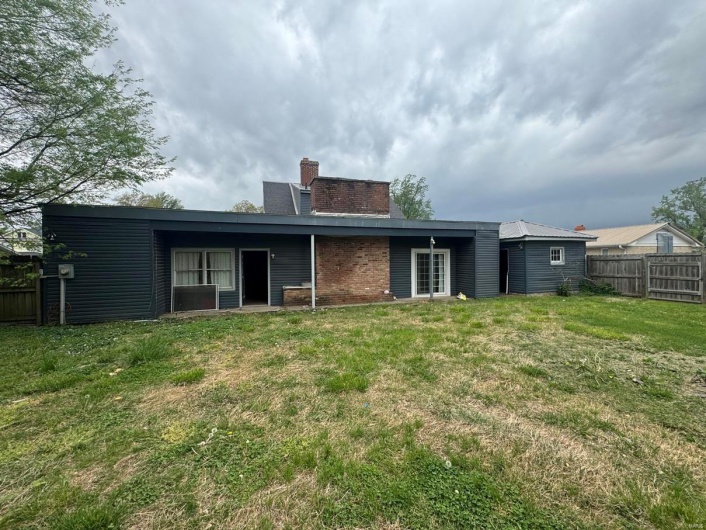 Rear view of property with a chimney