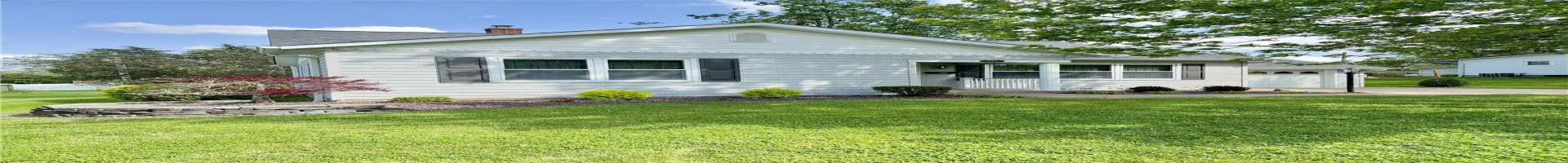 Residential For Sale View of front of home with concrete driveway, a shingled roof, a chimney, and a front lawn